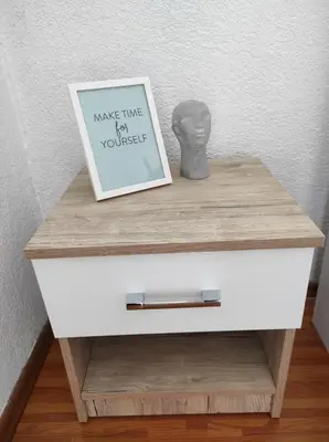 a picture on top of a drawer with a picture on it at Apartman 