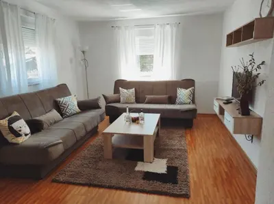 a living room with a couch and a coffee table at Apartman 