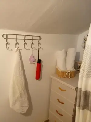 a bathroom with a towel hanging on a wall at Privatni smještaj Kurtalija in Jajce