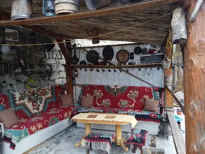 a living room with a red couch and a table at Privatni smještaj Kurtalija in Jajce