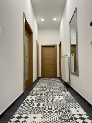 a hallway with a door and a tile floor at Penthouse City Center in Bihać
