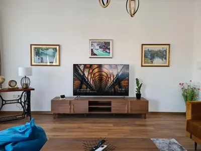 a living room with a flat screen tv on a wall at Penthouse City Center in Bihać