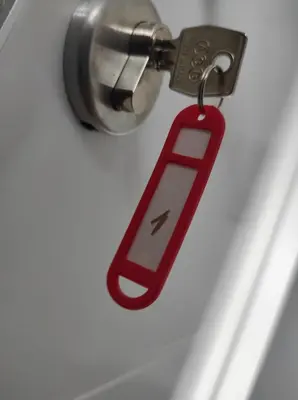 a red key chain with a cell phone on it at Prenoćište Ljiljana 2 in Livno