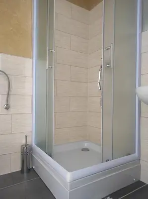 a shower with a glass door in a bathroom at Prenoćište Ljiljana 2 in Livno