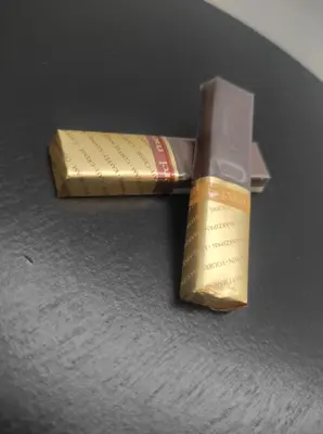 a chocolate bar and a wrapper on a table at Prenoćište Ljiljana 2 in Livno