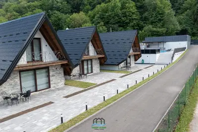 a row of cottages with black roof at Holiday Houses Green Queen in Bihać