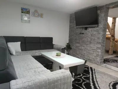 a living room with a couch and a table at Apartman Amina-Ahmad Vinac-Jajce in Jajce