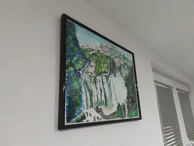 a painting hanging on a white wall with a window at Apartman Amina-Ahmad Vinac-Jajce in Jajce