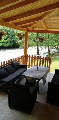 a patio with a table and chairs under a pavilion at Apartman Amina-Ahmad Vinac-Jajce in Jajce