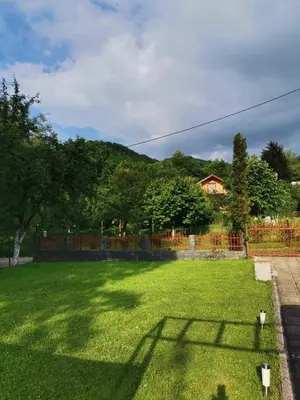 a large yard with a fence and a house at Relax house in Visoko