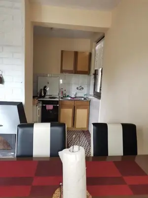 a kitchen with a table and two chairs in a room at Relax house in Visoko