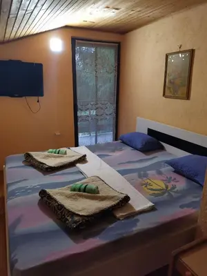 a bedroom with two beds with towels on them at Relax house in Visoko
