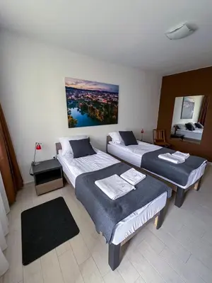 a room with three beds in a room at Happy Hill Rooms in Banja Luka