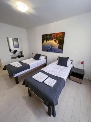 a room with two beds and a room with at Happy Hill Rooms in Banja Luka