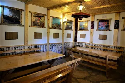 a room with benches and pictures on the walls at Apatments Radoja - Pliva in Šipovo