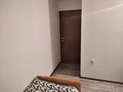 a small room with a door and a bed in it at Apatments Radoja - Pliva in Šipovo