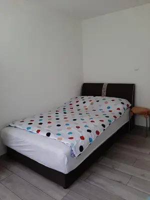 a bed sitting in a room with at Apartman Dujmović in Visoko