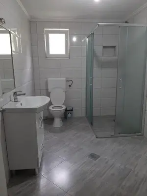 a bathroom with a toilet and a sink and a shower at Apartman Dujmović in Visoko