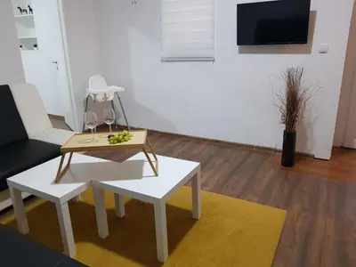 a living room with a coffee table and a couch at Apartmani Art in Jajce
