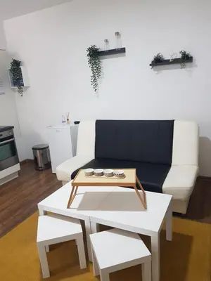 a living room with a couch and a coffee table at Apartmani Art in Jajce