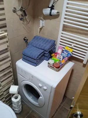 a washing machine with towels on top of it in a bathroom at Apartment Lazarus Banja Luka in Banja Luka