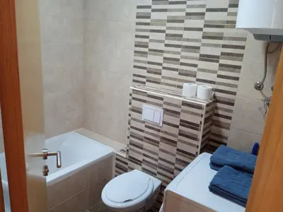 a bathroom with a toilet and a tub and a sink at Apartment Lazarus Banja Luka in Banja Luka