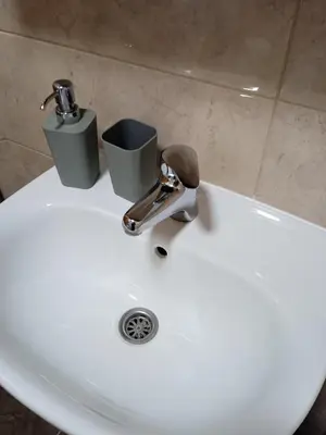 a sink with a faucet and two cups on it at Apartment Lazarus Banja Luka in Banja Luka