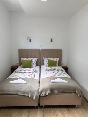 two beds sitting next to each other in a bedroom at Ravne Energy Apartments in Visoko