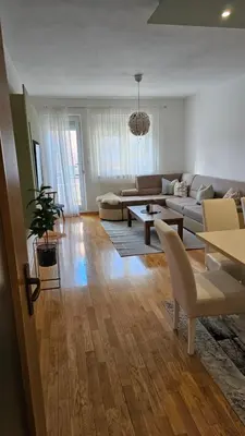 a living room with a couch and a table at Apartman Pati in Livno