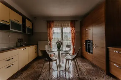 a kitchen with a table and chairs and a window at Villa Lamija in Bihać
