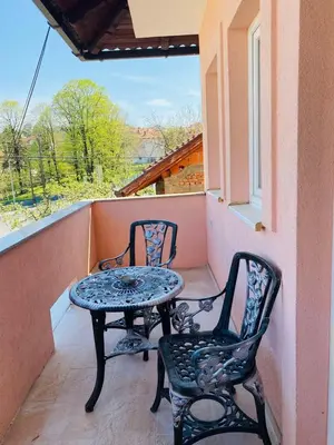 a table and two chairs on a balcony at Apartman Kula in Gradačac
