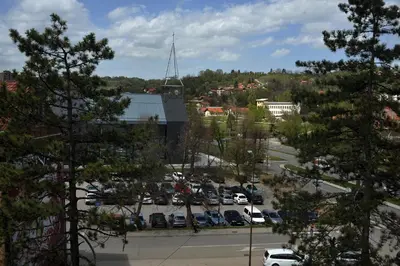 a parking lot with cars parked in a parking lot at Park Lake - Germa in Tuzla