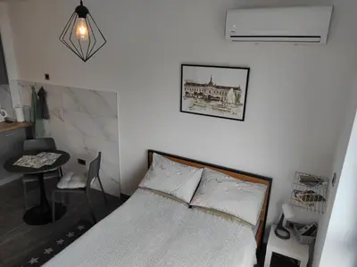 a bedroom with a bed and a picture on the wall at Park Lake - Germa in Tuzla