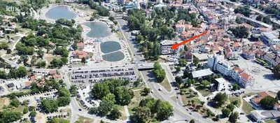 an aerial view of a city with a red arrow at Park Lake - Germa in Tuzla