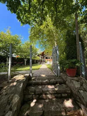 a stone pathway with a gate in front of a house at Lahor in Bihać