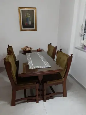 a dining room table with a laptop on top of it at Lahor in Bihać