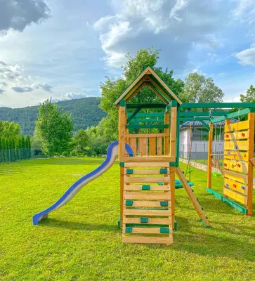 a playground with a slide and a play structure at Daman Villa in Bihać