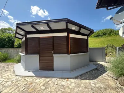 a small building with a roof on a patio at Vila Sana in Landeke