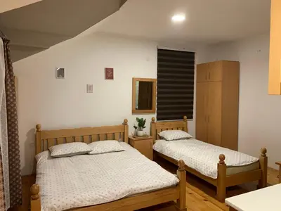 a bedroom with two beds and a window at Vila Sana in Landeke