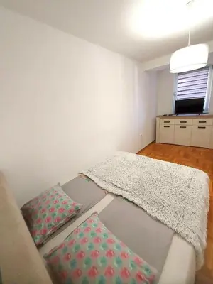 a living room with a couch with pillows on it at Apartman CITY CENTER 4-šetalište in Prijedor