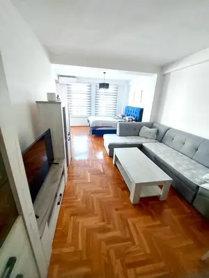 a living room with a couch and a flat screen tv at Apartman CITY CENTER 4-šetalište in Prijedor