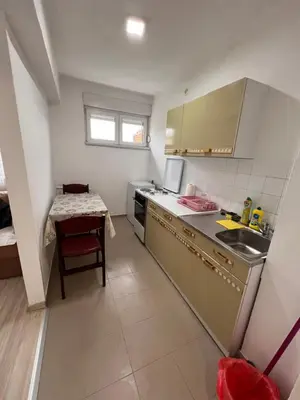 a small kitchen with a sink and a table at Babici 3 in Hiseti