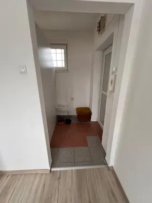 an empty room with a hallway with a window at Babici 3 in Hiseti