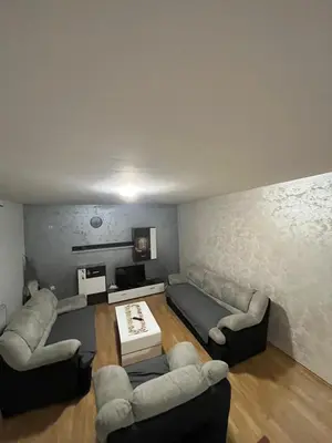 a living room with couches and a couch and a table at Apartman Lana in Doboj