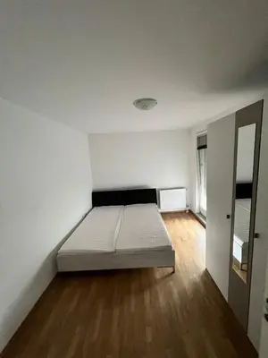 a bedroom with a bed in the middle of a room at Apartman Lana in Doboj