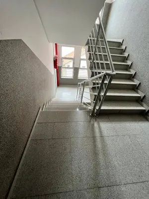 a stairway in a building with a metal railing at Apartman Lana in Doboj