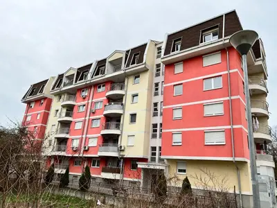 a tall apartment building with red and yellow at Apartman Lana in Doboj