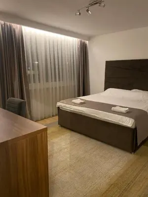 a hotel room with a bed and a window at Mia apartman Visoko in Visoko