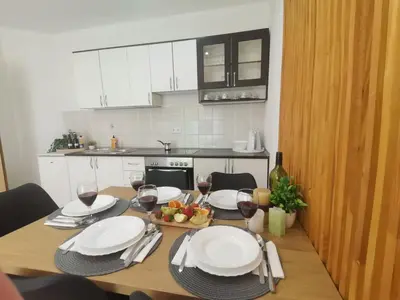 a table with glasses of wine and a bowl of fruit at King's Cave deluxe in Jajce