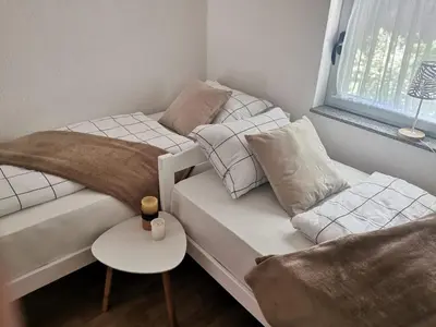 a bedroom with two beds and a couch and a table at King's Cave deluxe in Jajce